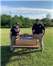 Police officers pose with game they are hosting