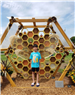 Boy in front of a giant beehive model