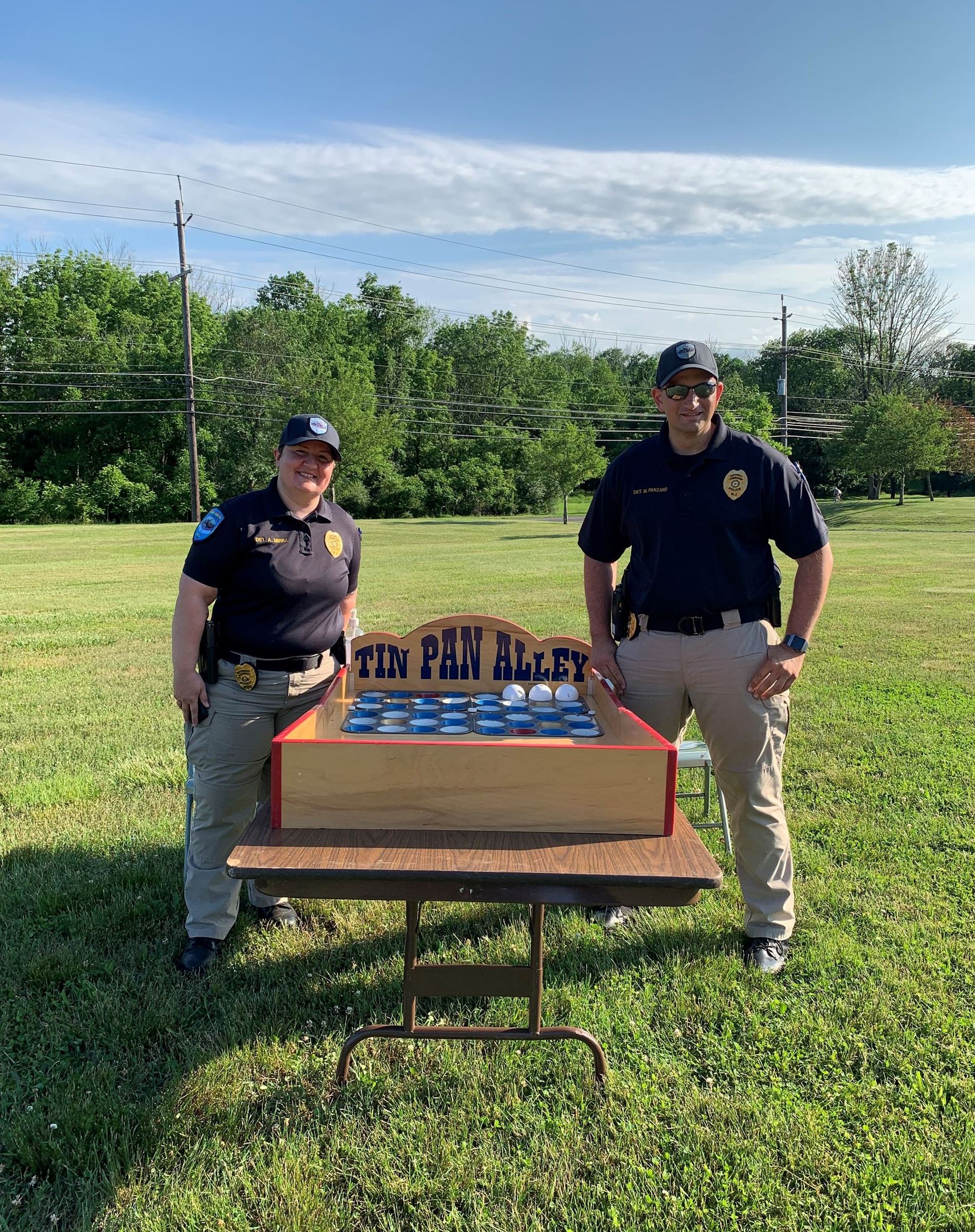 Police officers pose with game they are hosting