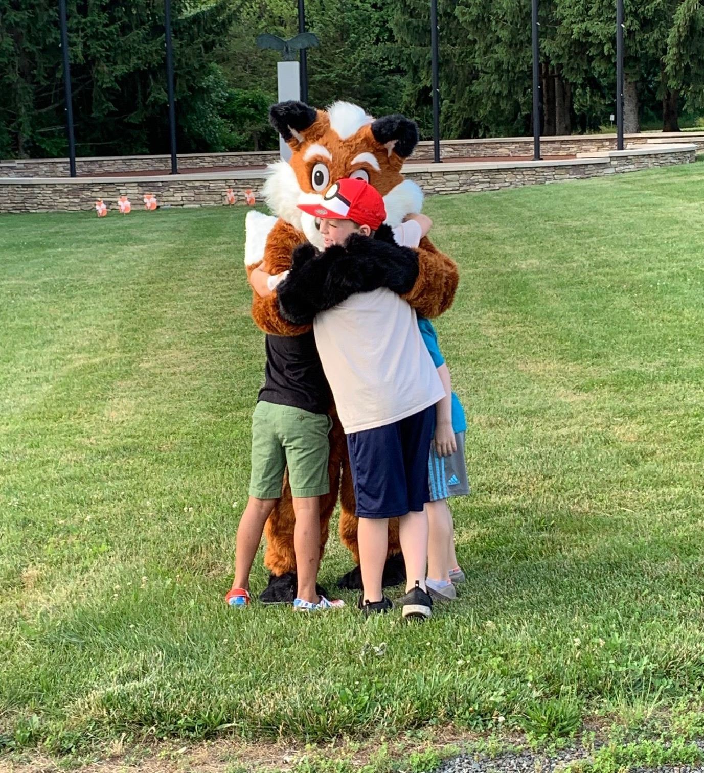 Children in front of fox mascot