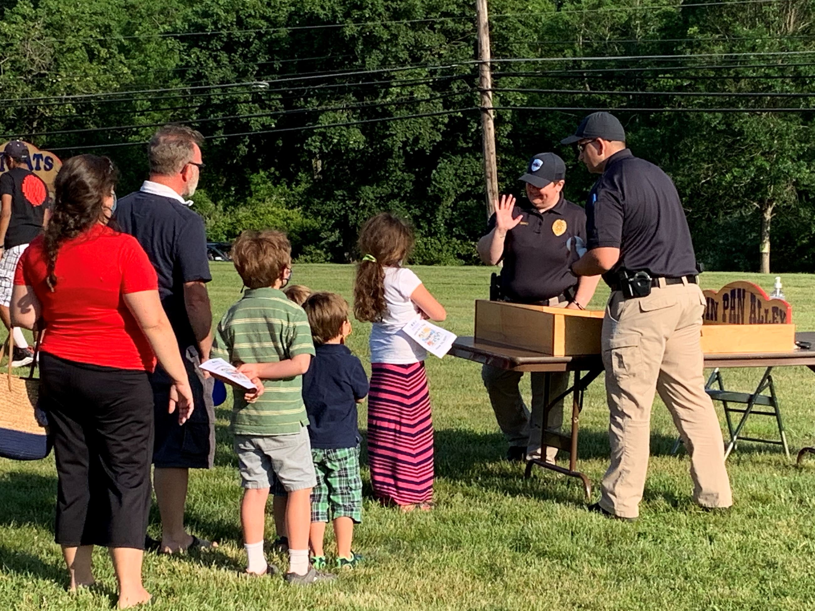 Kids in line to play a game with police officers