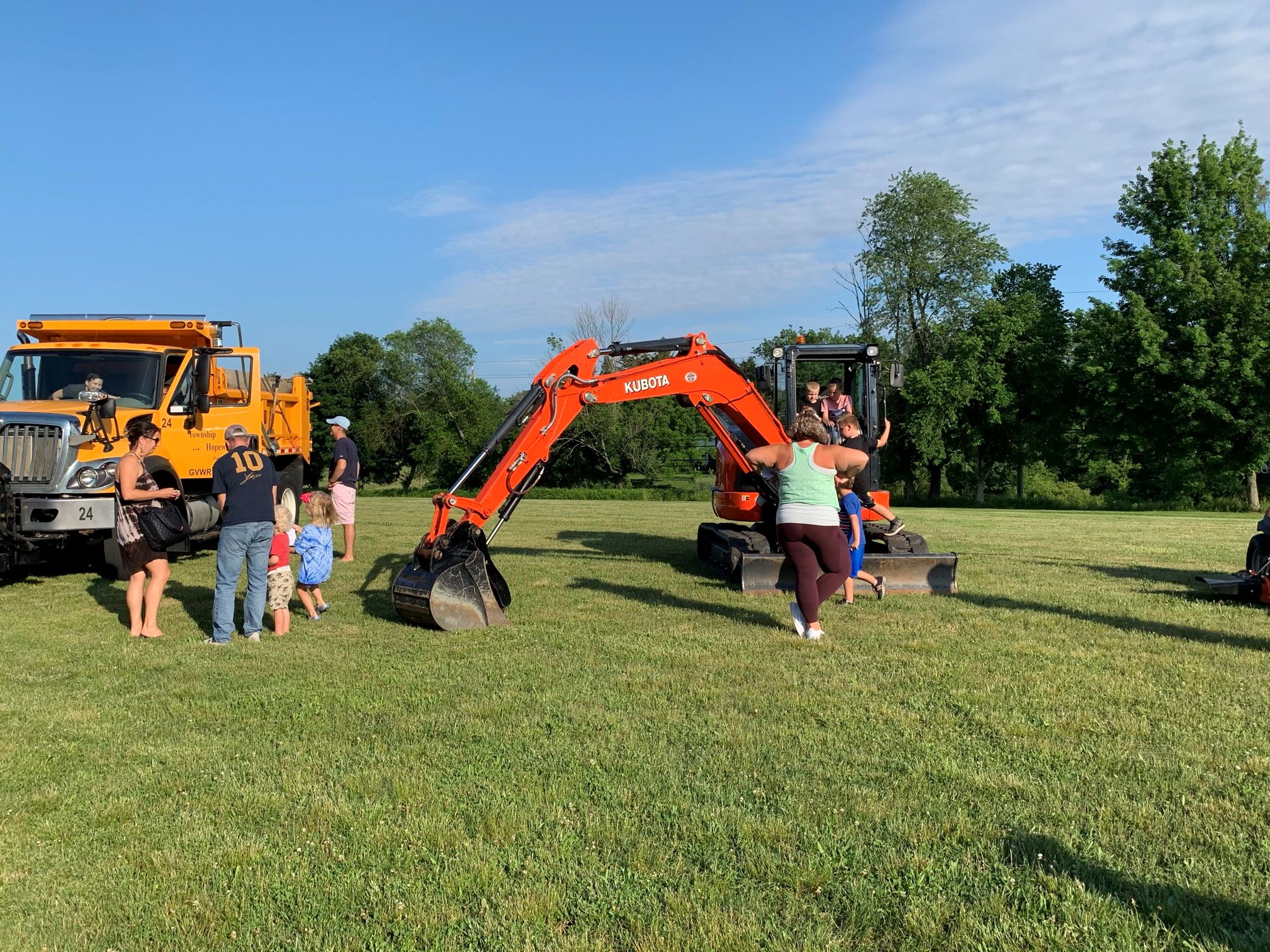 Parents and children in front of Public Works' machines