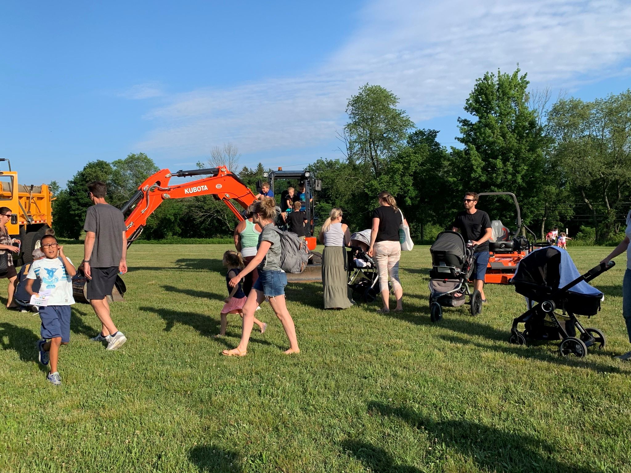 Parents and children in front of Public Works' machines