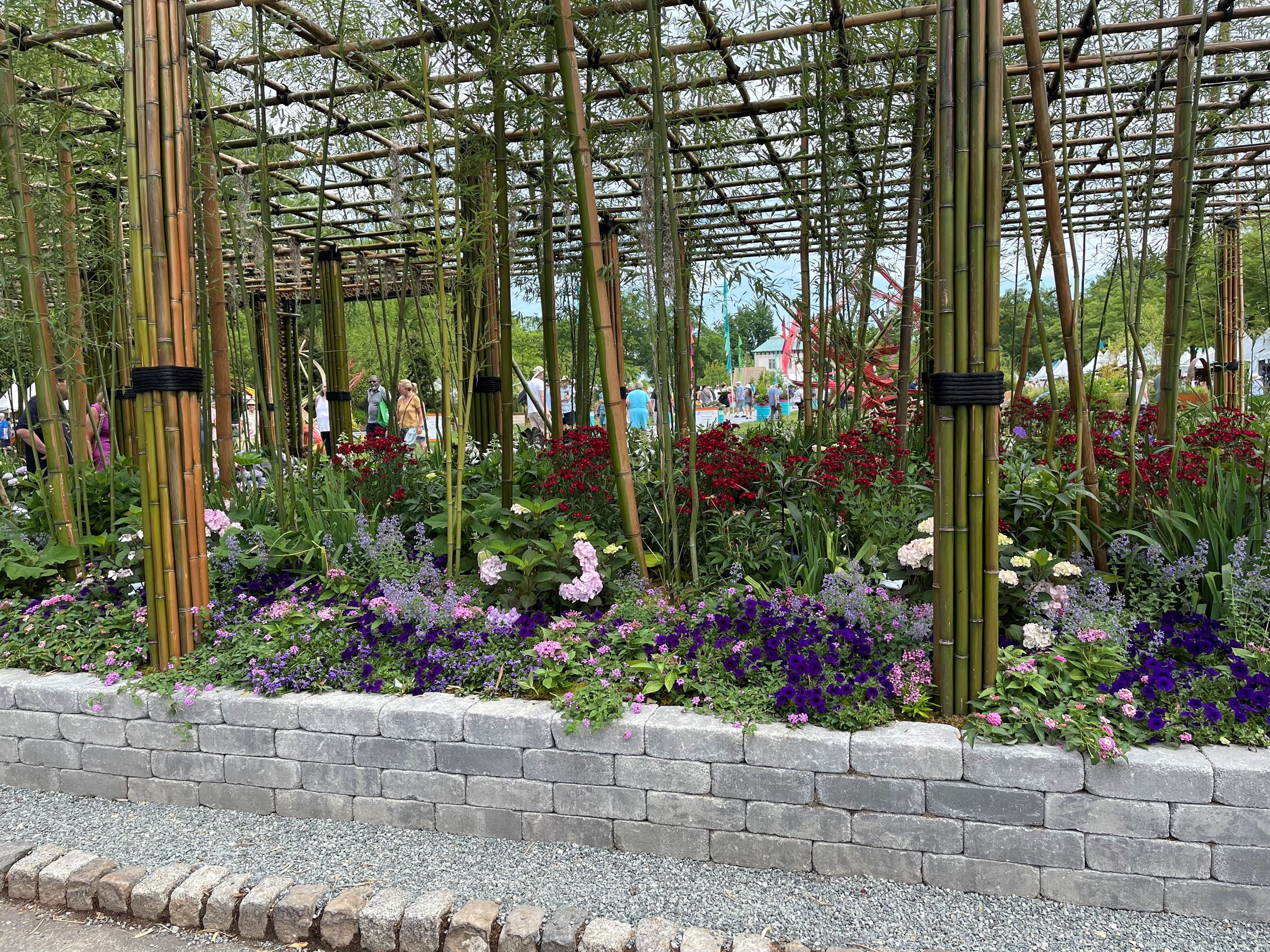 large flower garden under a trellis