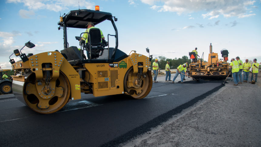 road paving truck and public works workers