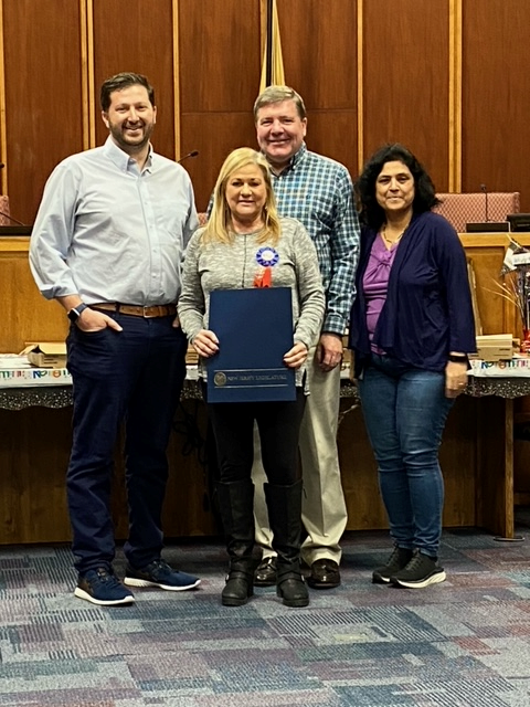 Laurie Gompf with Township Committee Members David Chait, Kevin Kuchinski, and Uma Purandare
