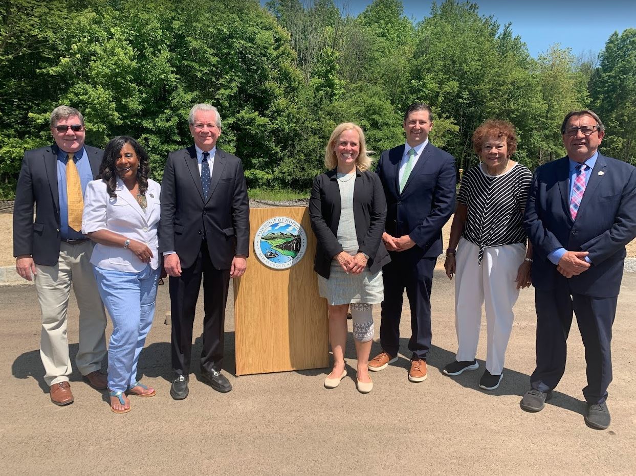 Sr Center announcement group of elected officials in front of dais with the township seal