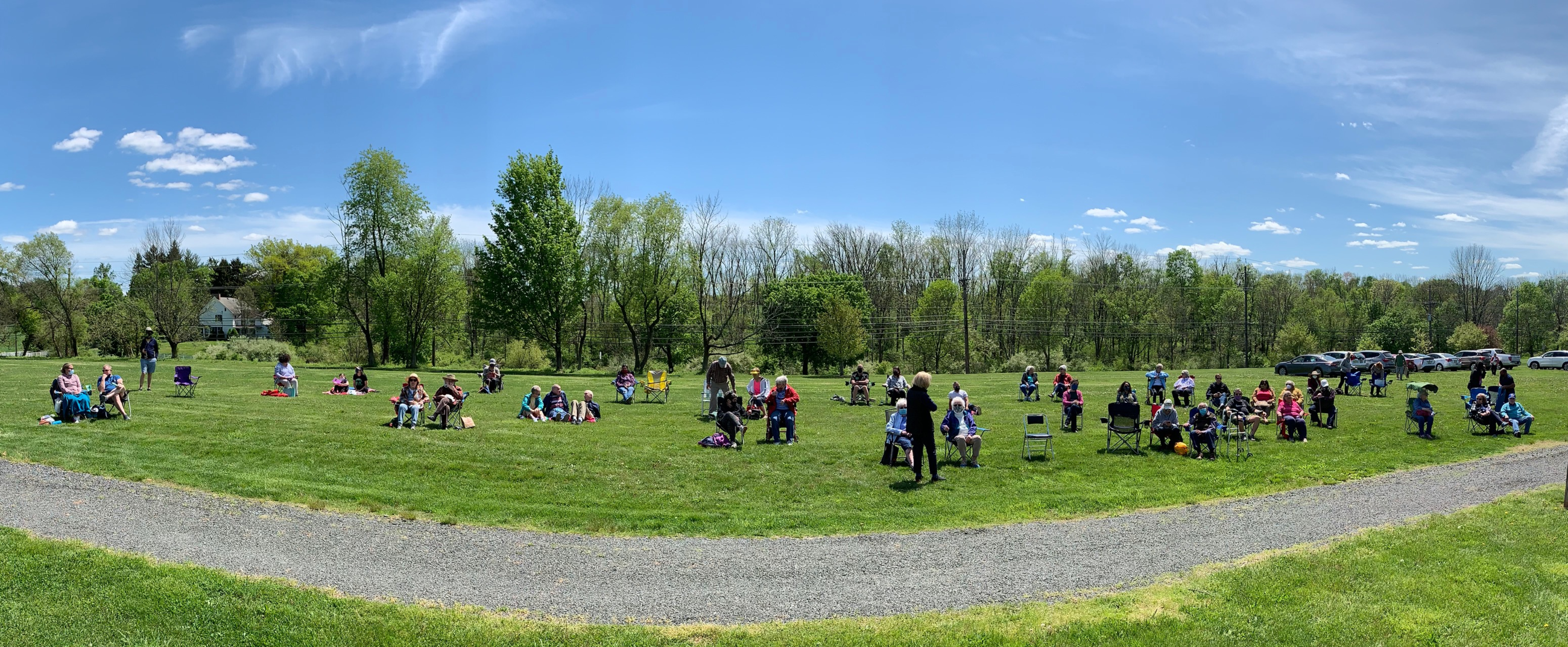 panorama of seniors in the sun, socially distanced.